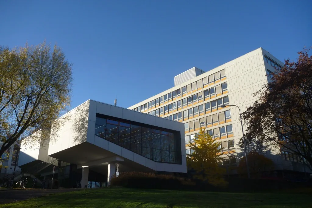 Moderne Gebäude der Fakultät für Bauingenieurwesen umgeben von Bäumen.